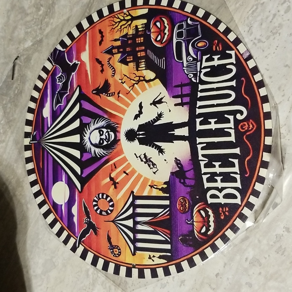 Beetlejuice round metal sign